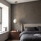 Minimalist alabaster mini pendant light with a gold frame, hanging above a wooden bedside table in a modern bedroom.