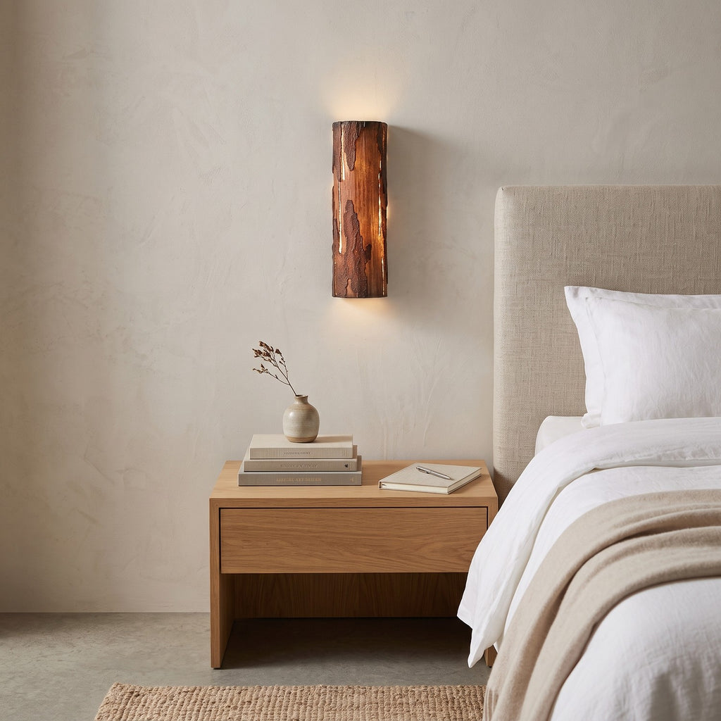 Bark Texture LED Wall Light – Model A in a serene bedroom beside an upholstered headboard and oak nightstand