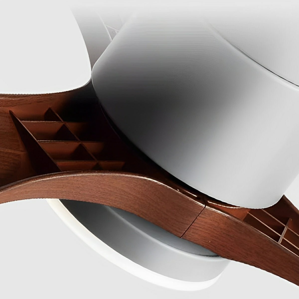 Scandinavian ceiling fan with white housing, integrated LED light, and curved walnut wood finish blades.