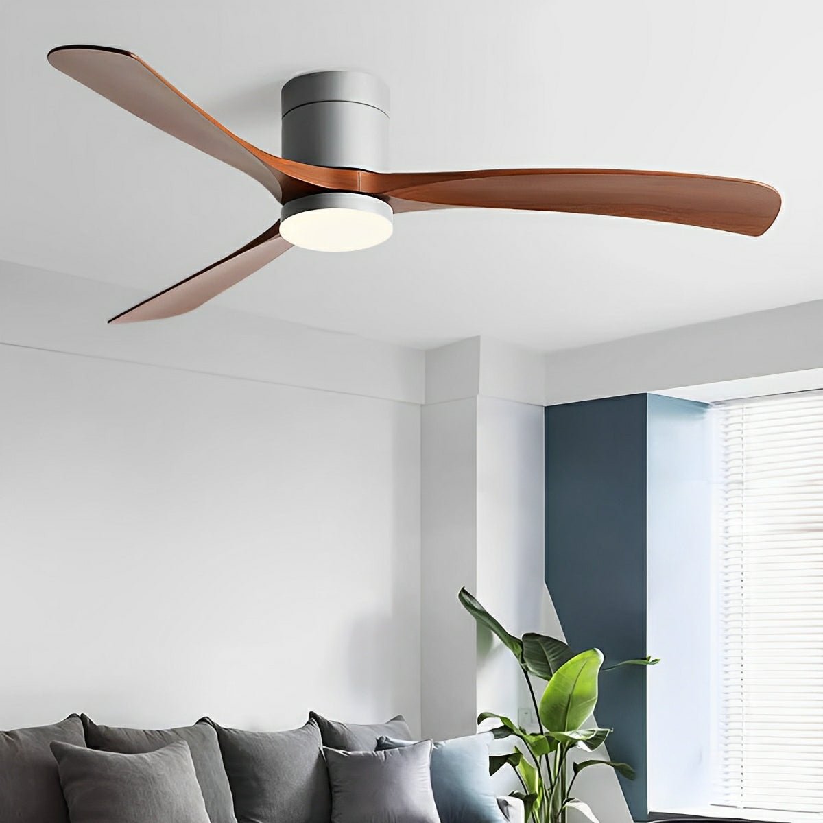 Scandinavian ceiling fan with walnut-finish blades, grey motor housing, and integrated LED light in a modern living room.