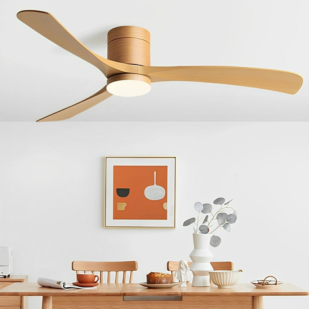 Scandinavian ceiling fan with light, featuring three light wood blades and an integrated LED in a modern dining room.