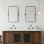 Sculptural clear glass pendant light with rippled texture hanging above a rustic double vanity in a modern bathroom.