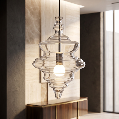 Sculptural clear glass pendant light with a rippled, theatre-inspired silhouette and a warm glowing filament bulb.