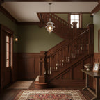 Sculptural clear glass pendant light with a rippled design hanging in a traditional wooden staircase hallway.