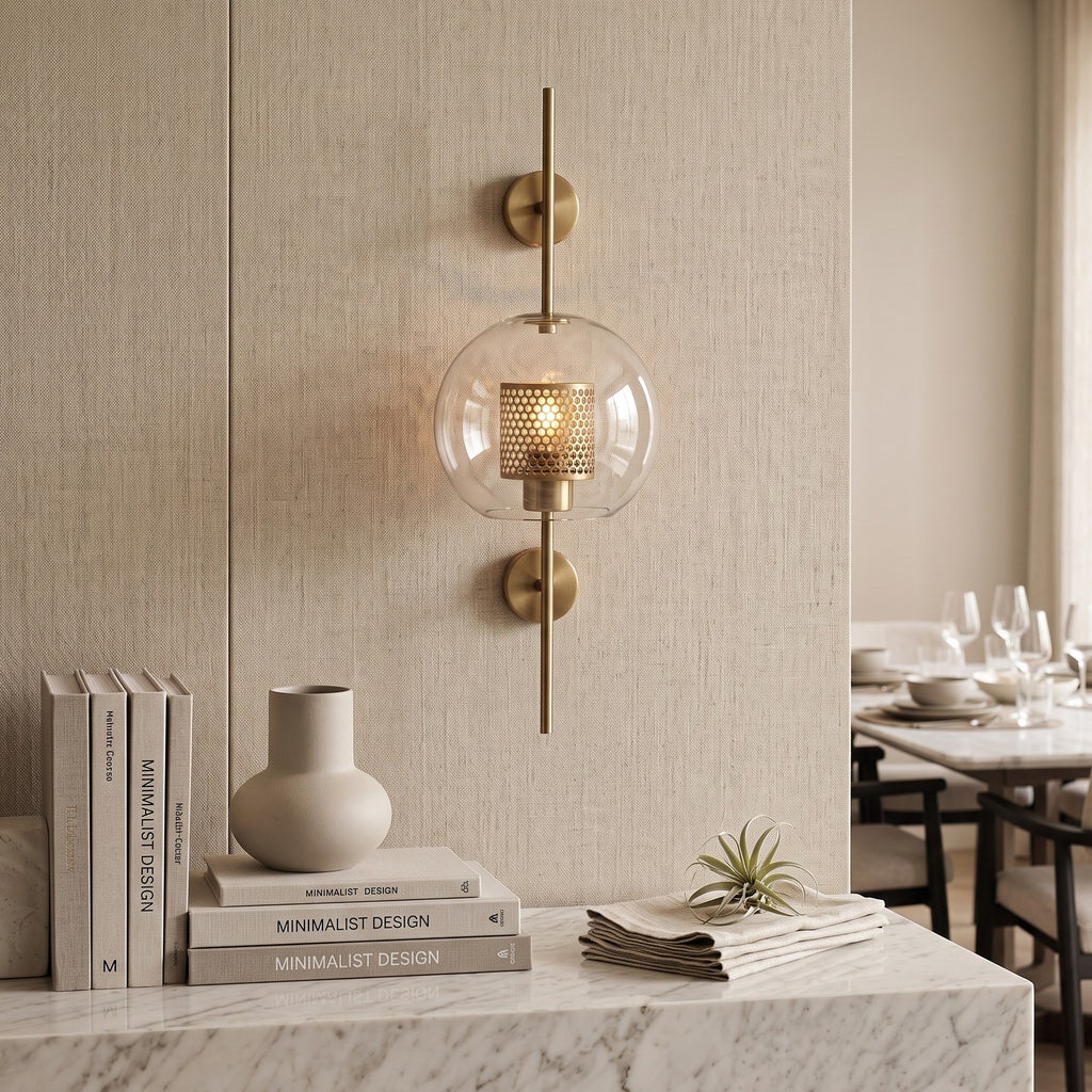Clear Glass Wall Light – Brass / A in an elegant dining room above a marble sideboard
