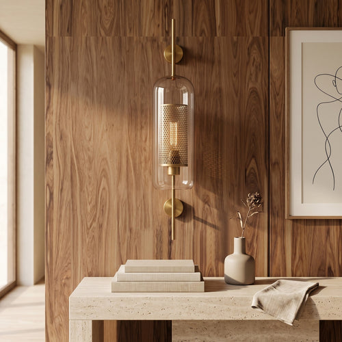 Clear Glass Wall Light – Brass / B in a bright living room above a travertine console