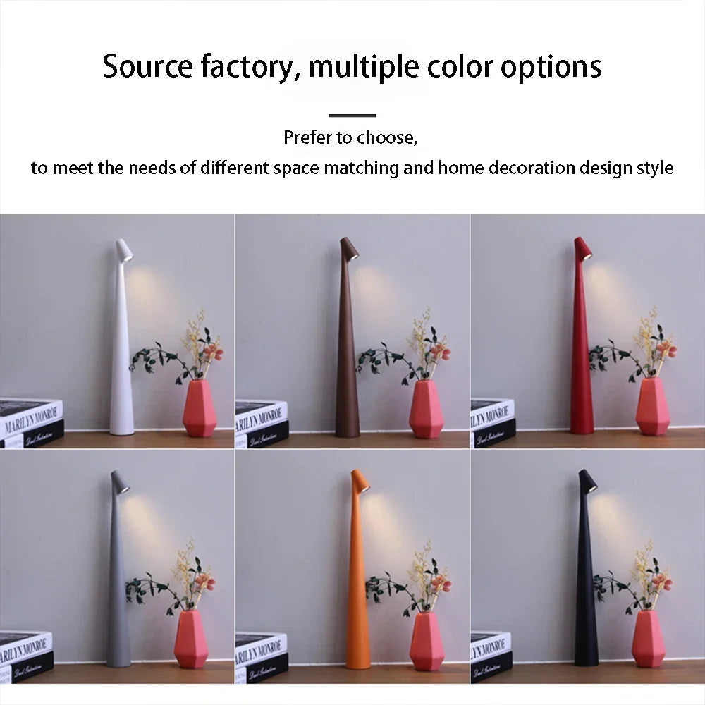 Six slim, 33cm cordless LED table lamps in white, brown, red, grey, orange, and black displayed on a shelf.