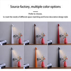 Six slim, 33cm cordless LED table lamps in white, brown, red, grey, orange, and black displayed on a shelf.