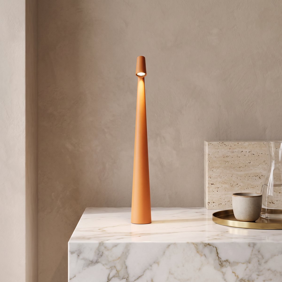 Slim orange cordless LED table lamp with a minimalist 33cm tall design, sitting on a white marble surface.