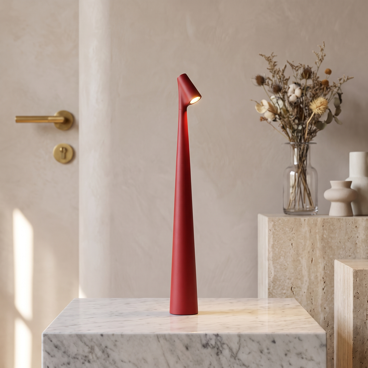 Slim red cordless LED table lamp with a minimalist 33cm tall design, glowing on a white marble pedestal.