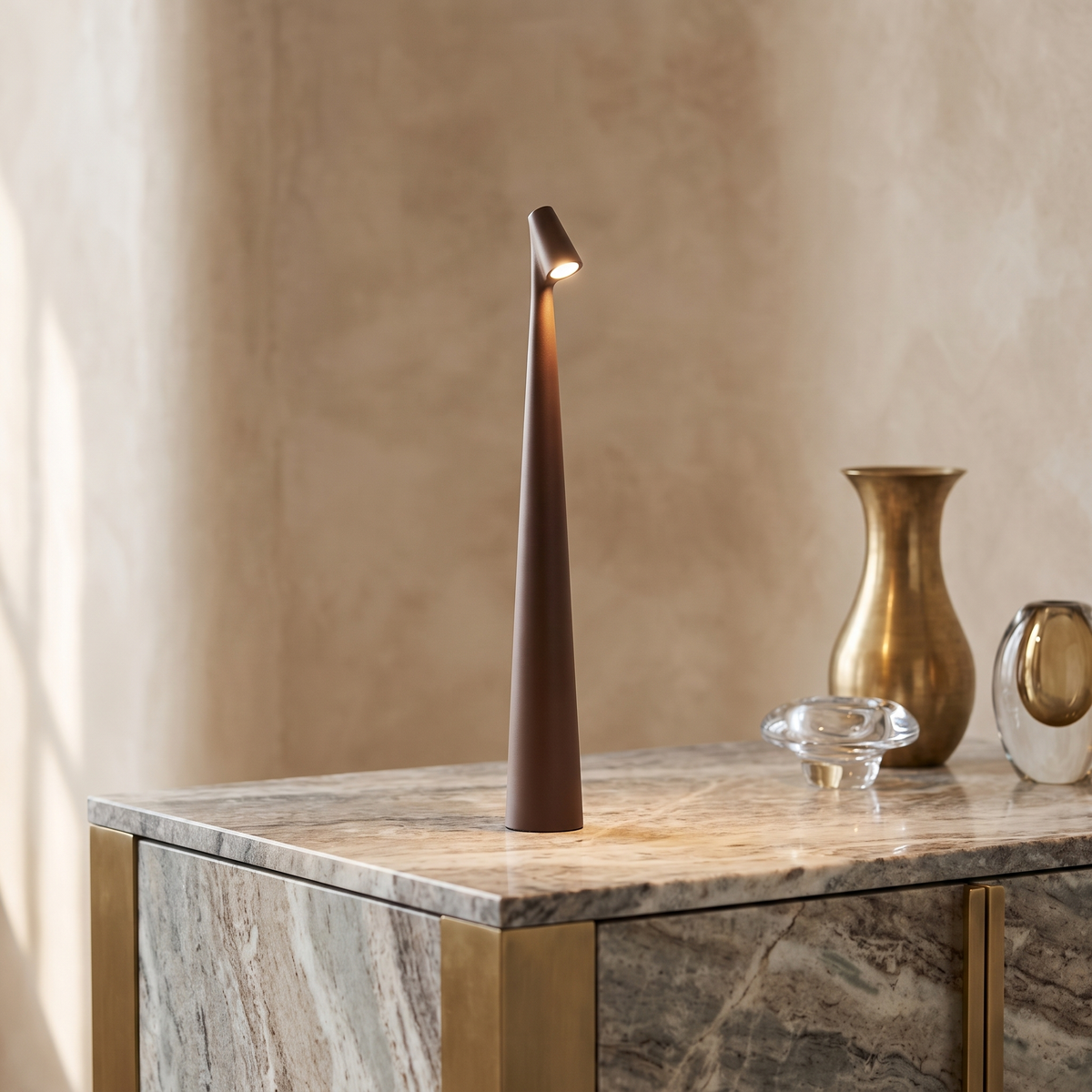 Slim brown cordless LED table lamp with a minimalist 33cm tapered design, glowing on a marble console table.
