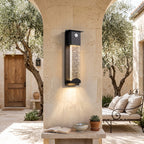 Crystal Effect Outdoor Wall Light – SENSOR in a courtyard with olive trees and limestone walls