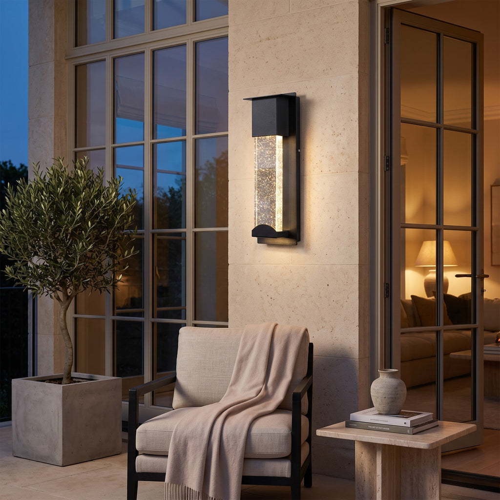 Crystal Effect Outdoor Wall Light – STEADY in a stone terrace beside large glass doors at dusk