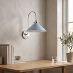 Curved Arm Cone Wall Light – Nickel+Blue in a calm home office above a solid oak desk