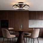 Modern black flush mount ceiling fan with integrated LED flower-petal design installed in a contemporary dining room.