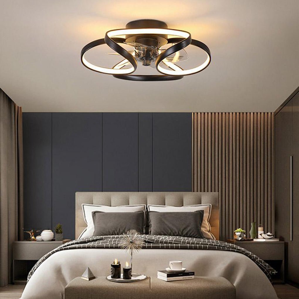 Modern black flush mount ceiling fan with integrated LED flower petal design installed in a contemporary bedroom.