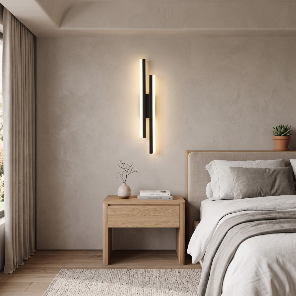 Geometric LED Wall Light – Black / Left in a serene bedroom beside an upholstered headboard and oak nightstand