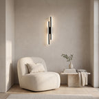 Geometric LED Wall Light – Black / Right in a quiet reading corner above a boucle armchair