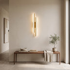 Geometric LED Wall Light – Gold / Left in an entrance hall above a slim walnut bench