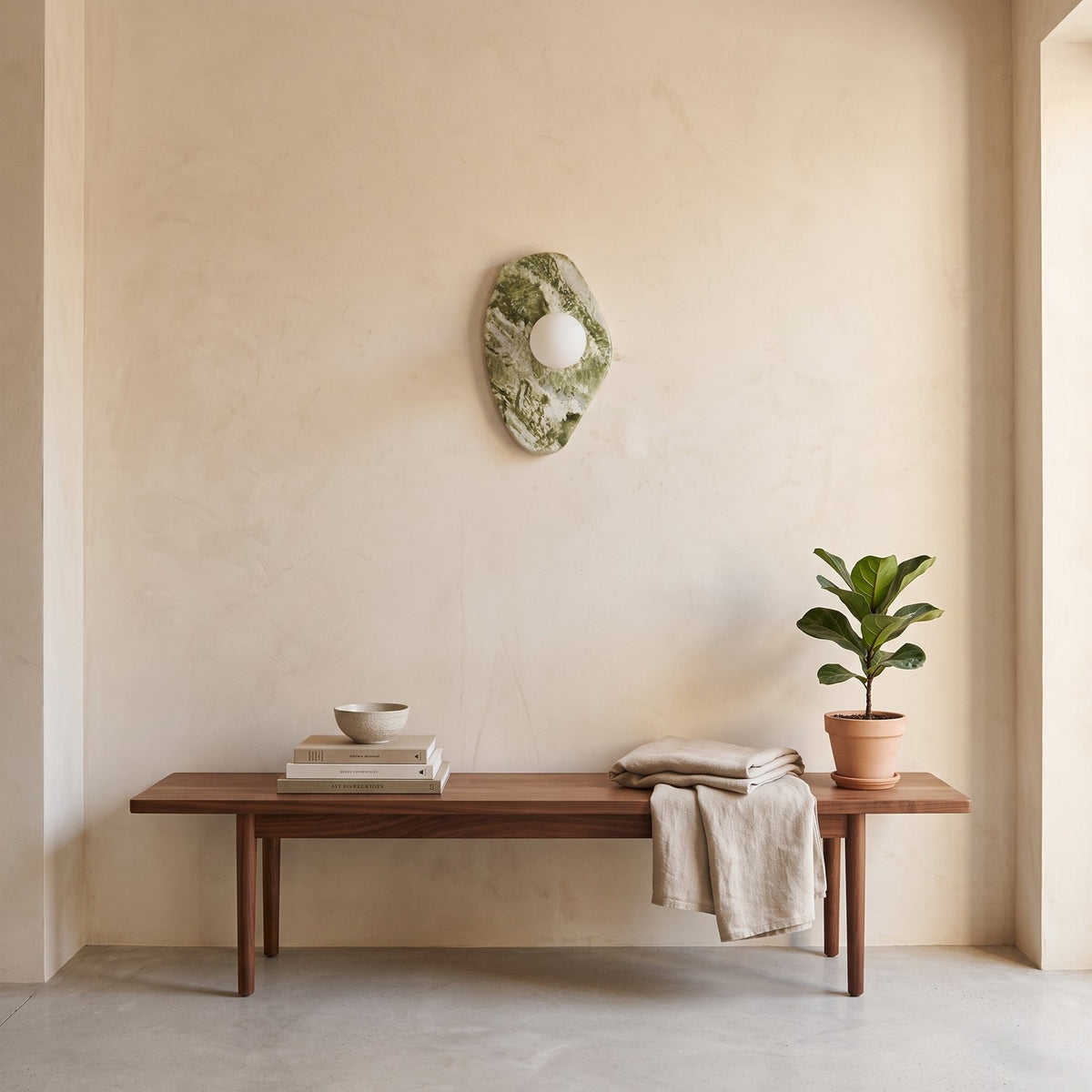 Green Marble Wall Light – Model A in an entrance hall above a slim walnut bench