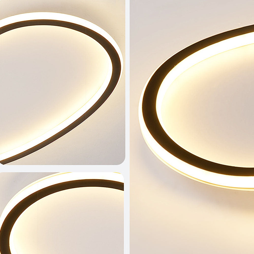 Minimalist black aluminum flush ceiling light with a soft, continuous silicone LED diffuser for glare-free illumination.