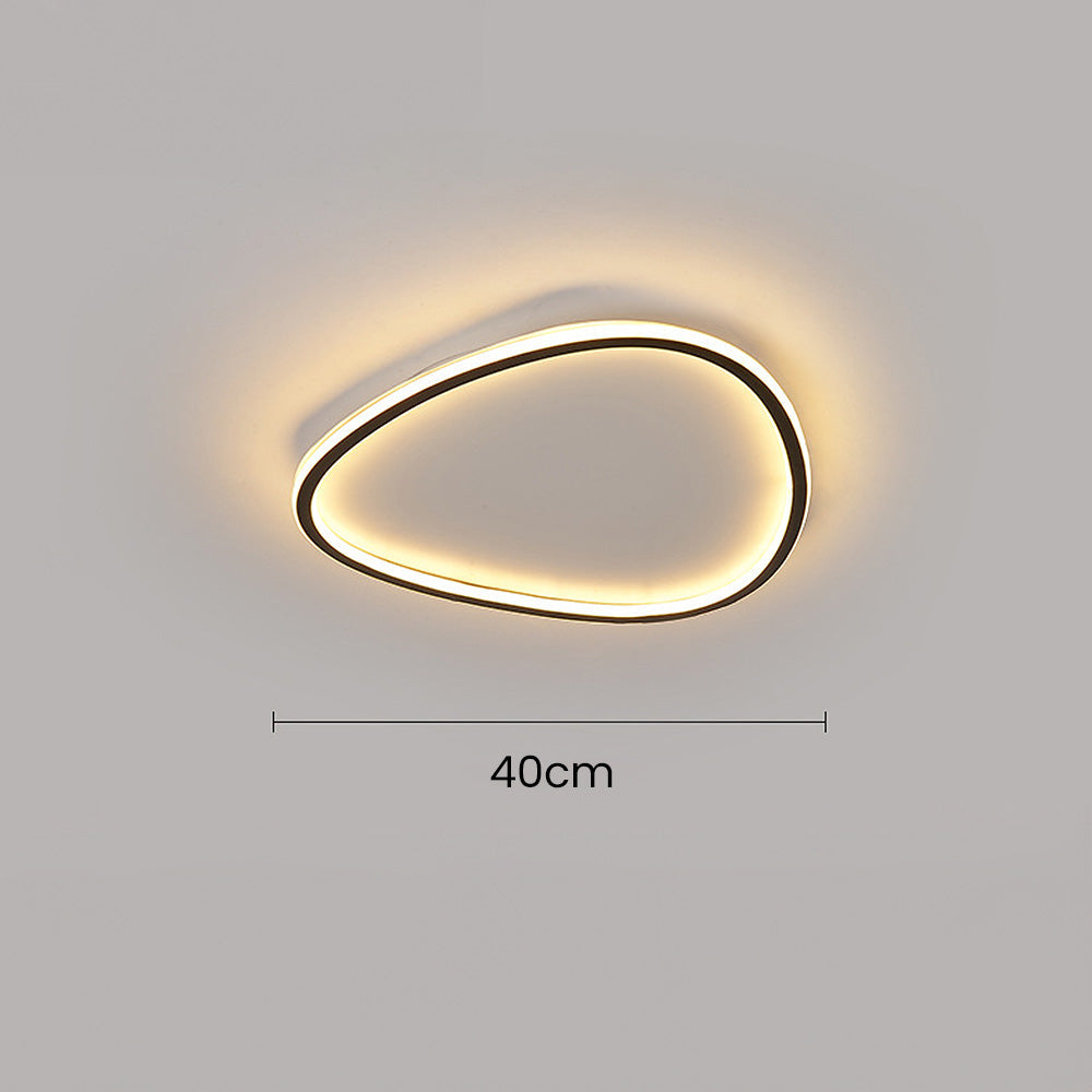 Minimalist 40cm black aluminium flush ceiling light with a soft, glowing integrated LED silicone diffuser.