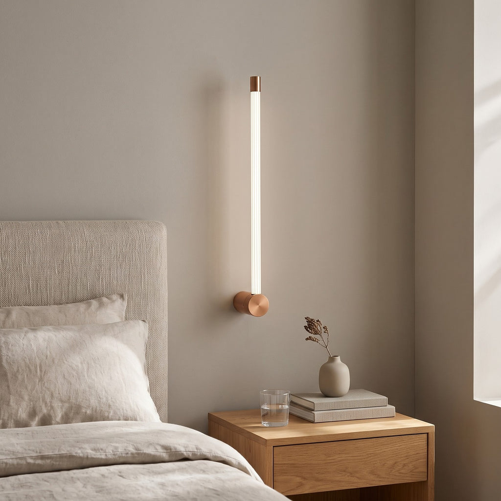 LED Tube Wall Light – Copper-end in a serene bedroom beside an upholstered headboard and oak nightstand