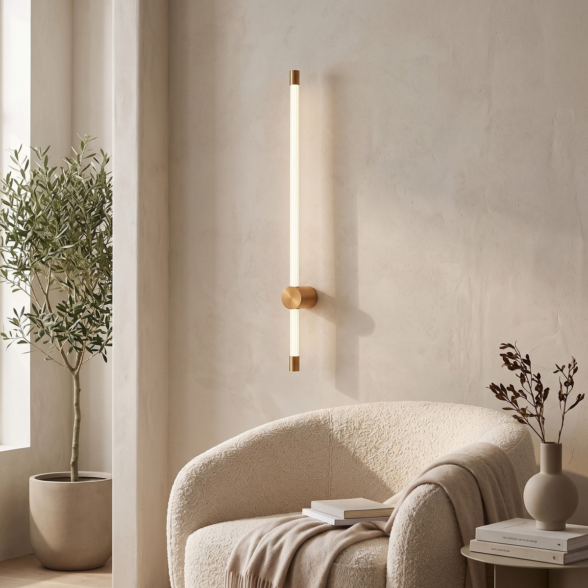 LED Tube Wall Light – Copper-mid in a quiet reading corner above a boucle armchair
