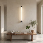 LED Tube Wall Light – Black-end in an entrance hall above a slim walnut bench
