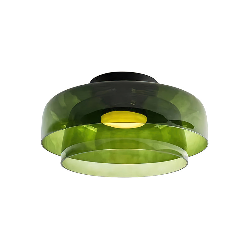 Retro layered ceiling light featuring stacked green glass tiers that create soft, tinted gradients of warm light.