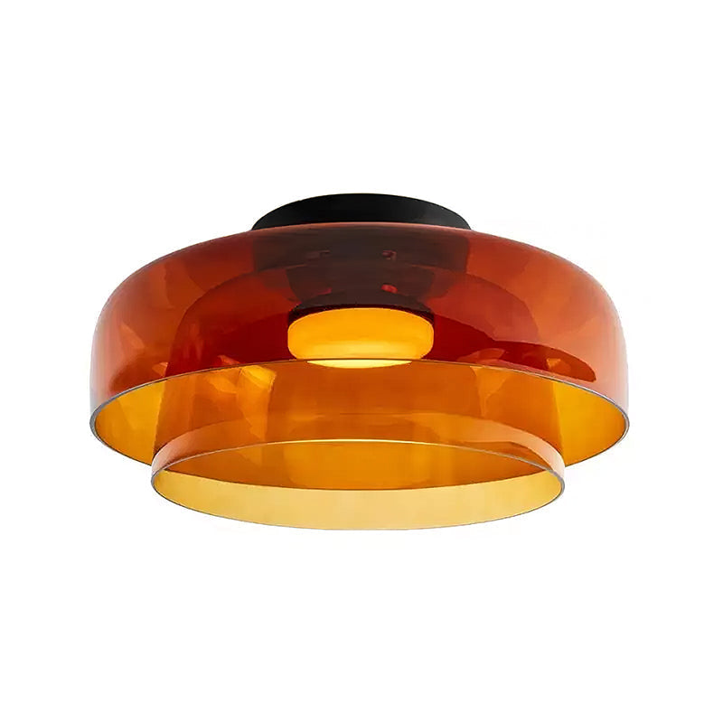 Retro layered ceiling light featuring stacked orange glass tiers that create a warm, glowing gradient effect.