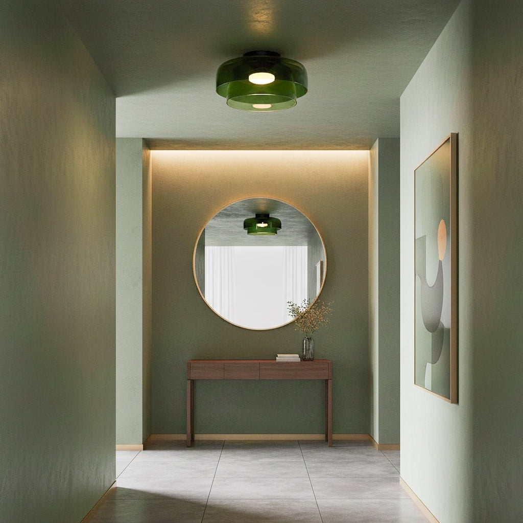 Green layered glass ceiling light in a retro design, mounted in a modern hallway with a round mirror and wooden console table.