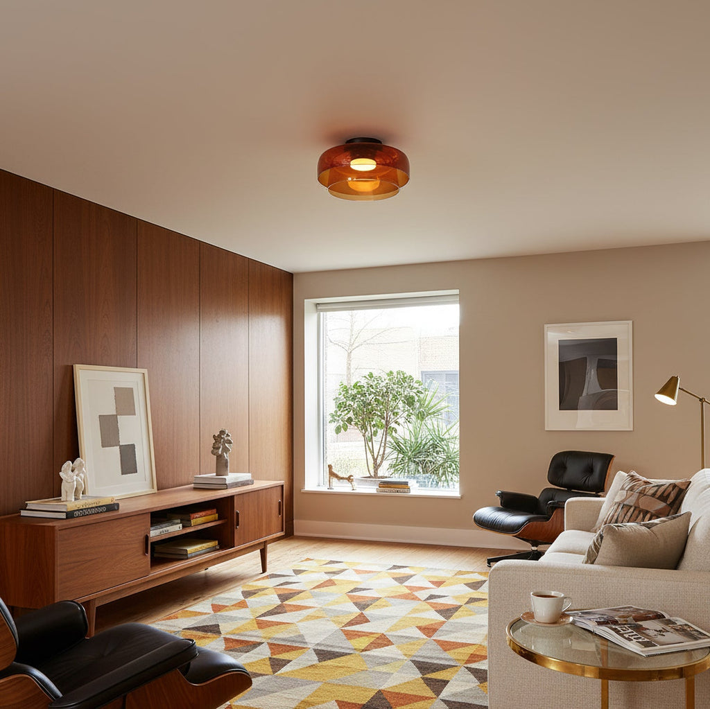 Retro layered orange glass ceiling light fixture in a mid-century modern living room with wood paneling.