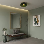 Retro green layered glass ceiling light with a stacked design, illuminating a modern entryway with a bench and mirror.