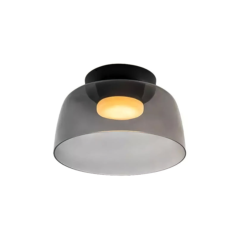 Retro layered ceiling light with smoky grey glass tiers and a warm glowing center on a black mount.