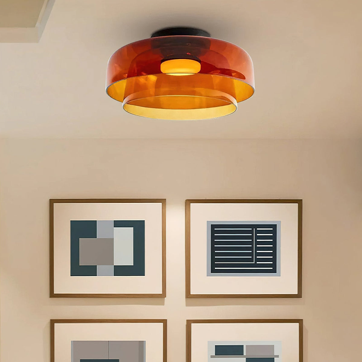 Retro layered orange glass ceiling light with a stacked design, casting a warm glow in a modern interior.