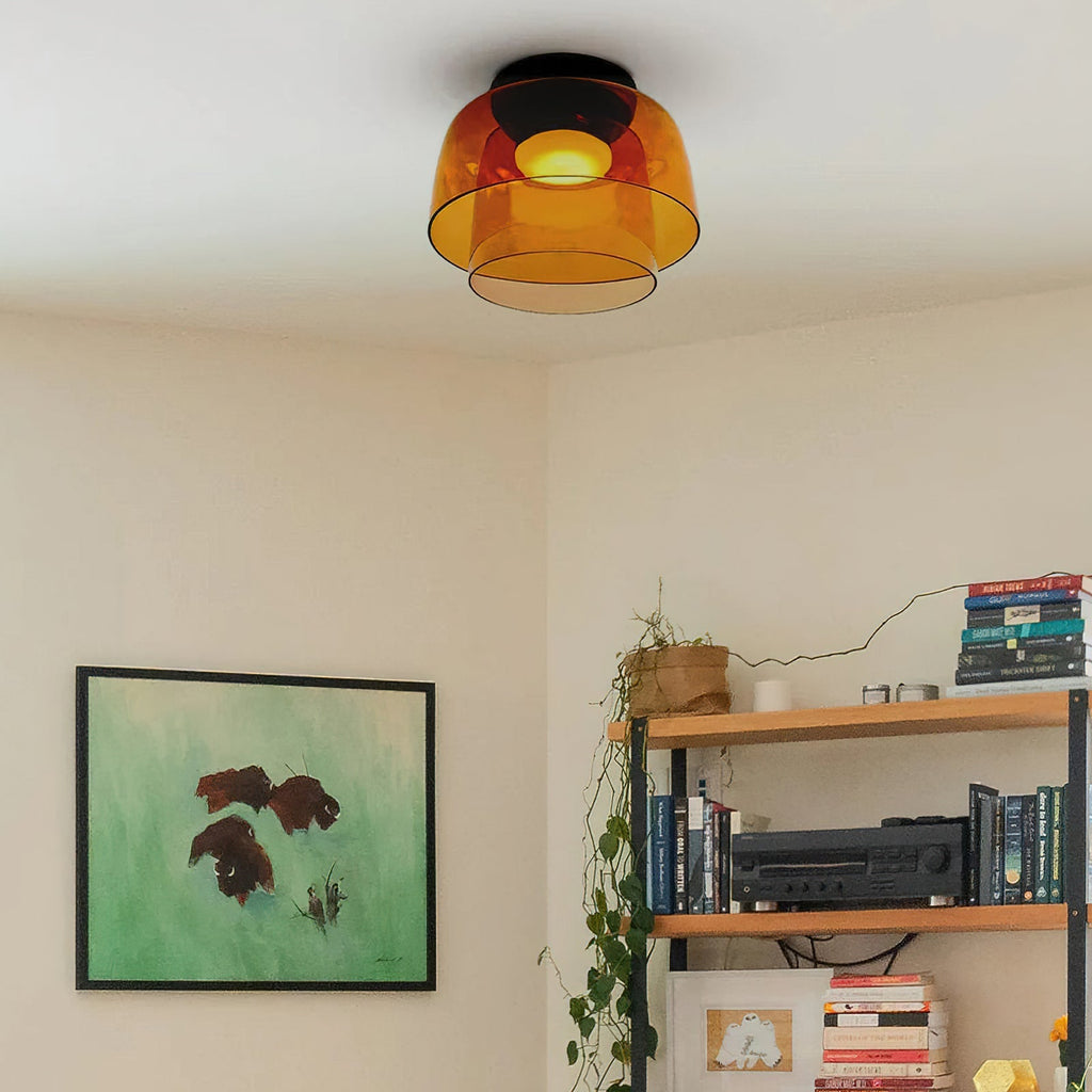 Retro orange layered glass ceiling light with a warm glow, mounted on a white ceiling in a living room.