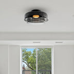 Retro layered ceiling light with smoky grey glass tiers and a warm glowing center, mounted on a white ceiling.