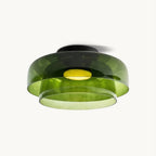 Retro layered green glass ceiling light with stacked tiers and a warm glowing center on a white background.