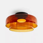 Retro layered ceiling light featuring stacked orange glass tiers that create a warm, glowing gradient effect.
