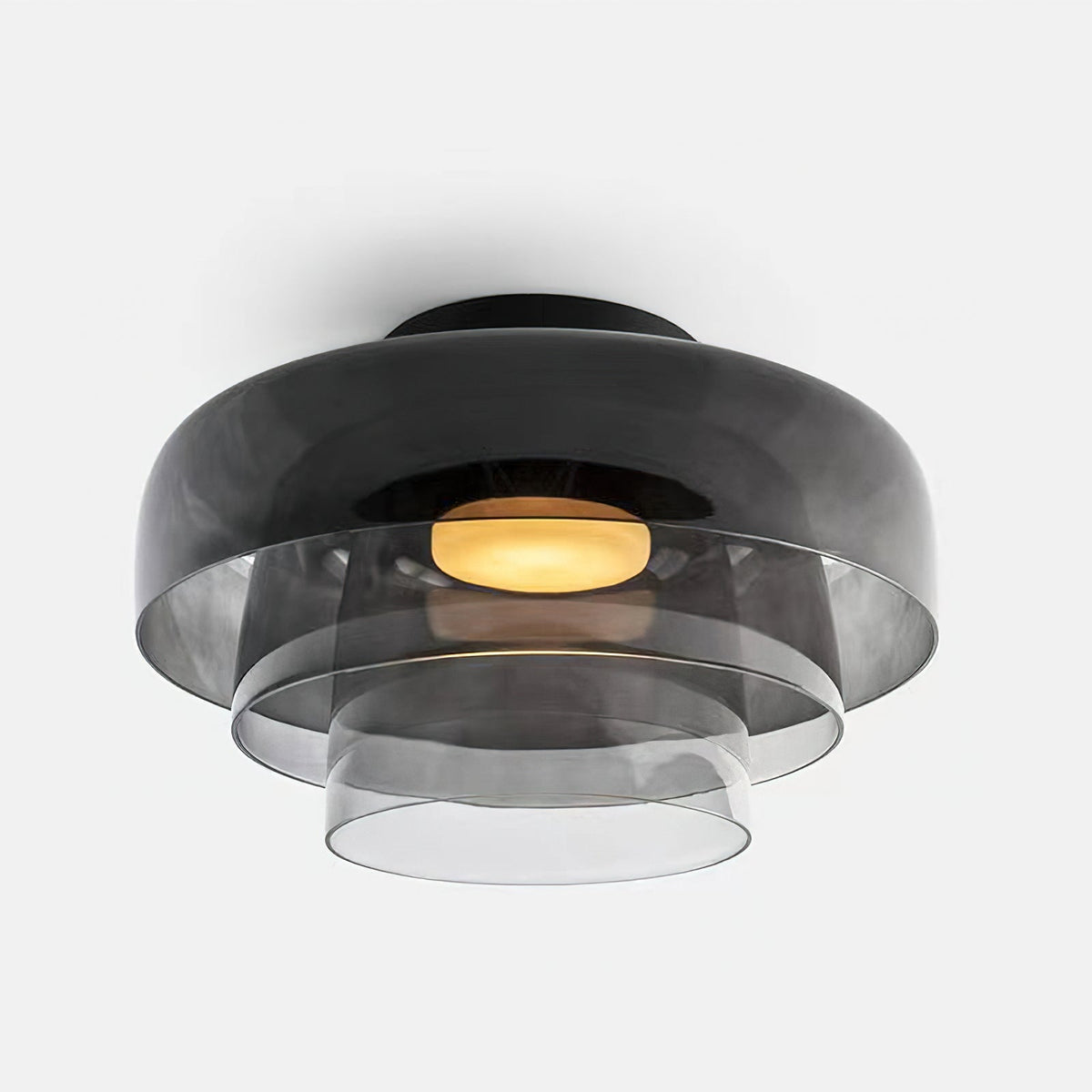 Retro layered ceiling light in smoky grey glass with stacked tiers and a warm glowing center on a white background.