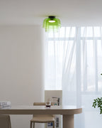 Retro green layered glass ceiling light with a stacked design, mounted in a bright, modern dining room.
