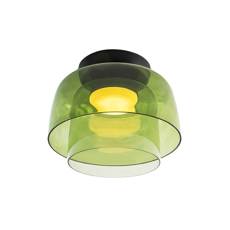 Retro layered ceiling light featuring stacked green glass tiers with a warm glowing center on a black mount.