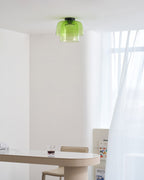 Retro layered green glass ceiling light with a stacked design in a modern dining room.