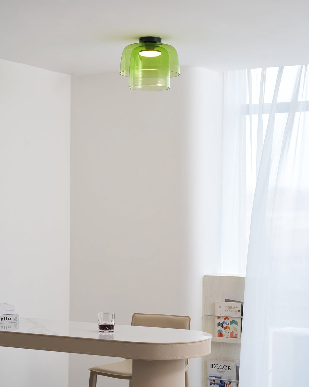 Retro layered green glass ceiling light with a stacked design, mounted in a bright, modern interior space.