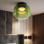 Retro layered green glass ceiling light with stacked tiers emitting a warm, soft glow in a modern bedroom interior.