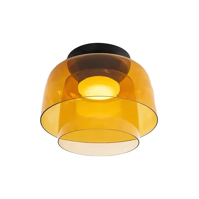 Retro layered ceiling light with stacked orange glass tiers and a warm glowing center on a black mount.
