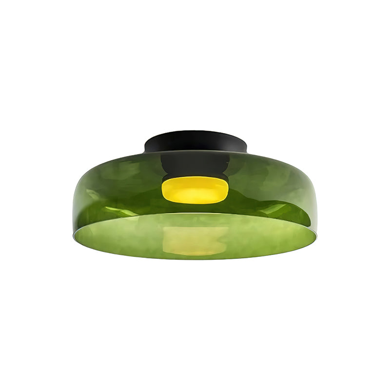 Retro layered green glass ceiling light with a warm glowing center and black mount.