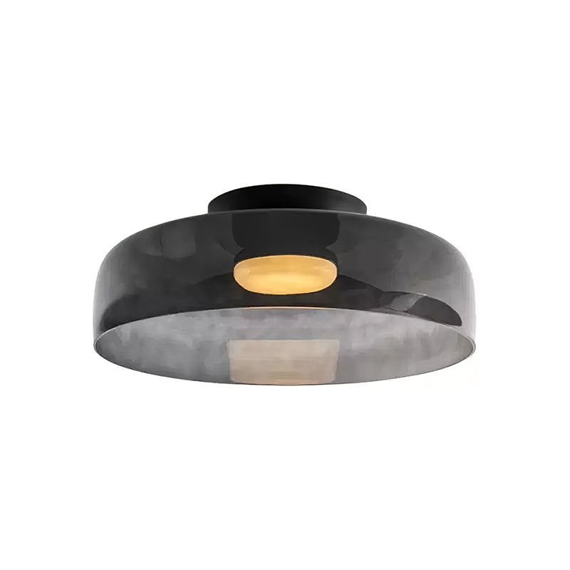 Retro layered smoky grey glass ceiling light with a warm glowing center and black mount.