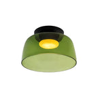 Retro green glass ceiling light with a layered design and warm glowing center, mounted on a black base.